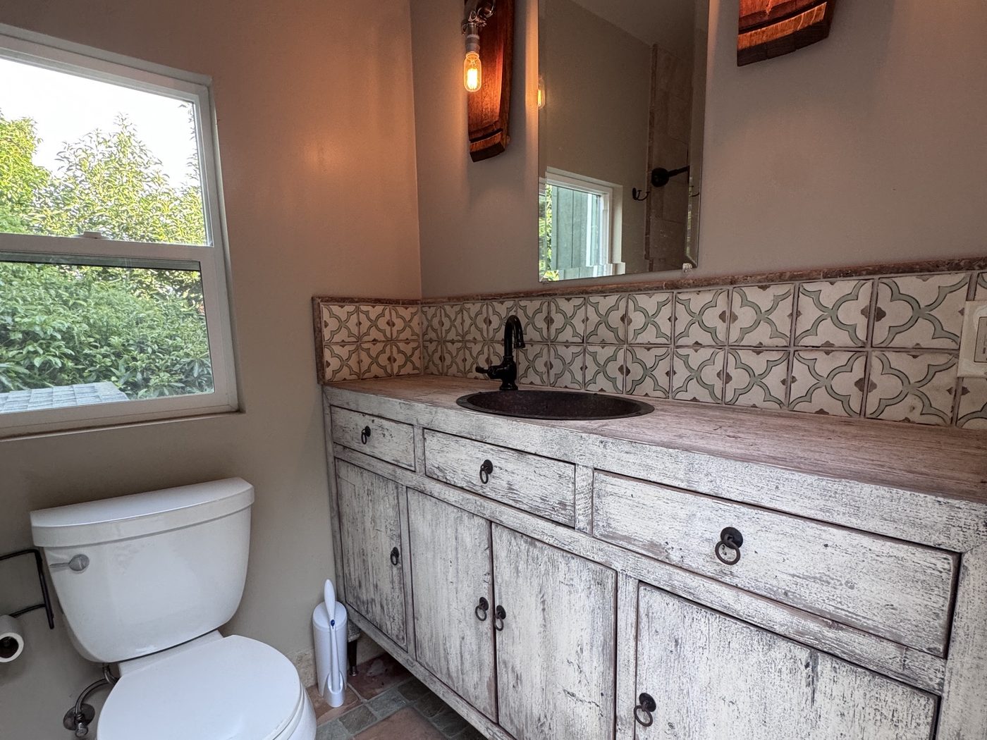 Full bath in the barn studio with Spanish tile and reclaimed-wood vanity