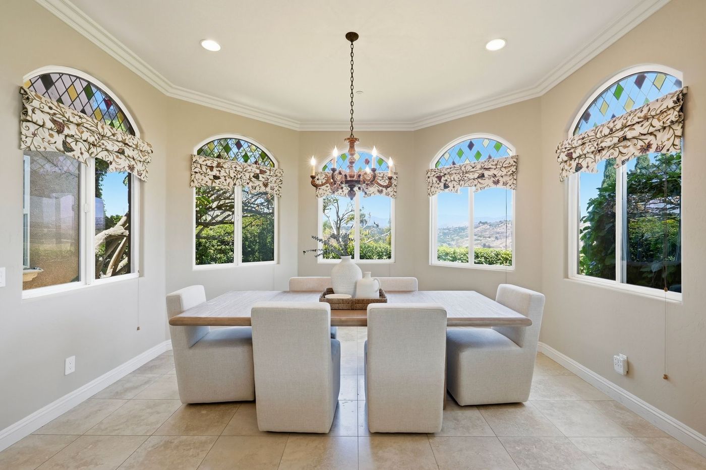 Dining bay with stained-glass arched windows and valley views