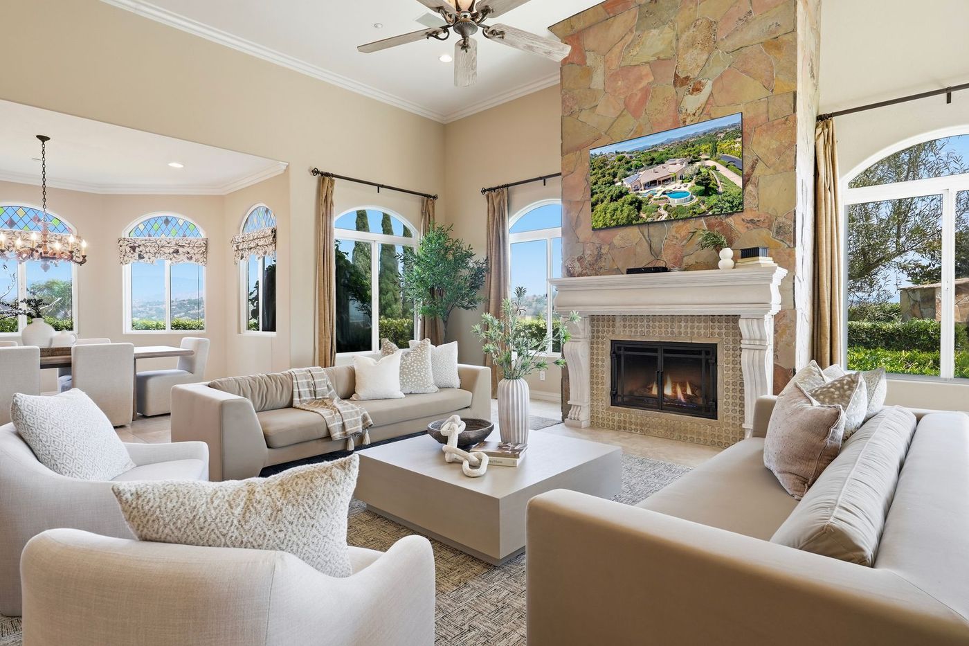 Great room with floor-to-ceiling stone and limestone fireplace