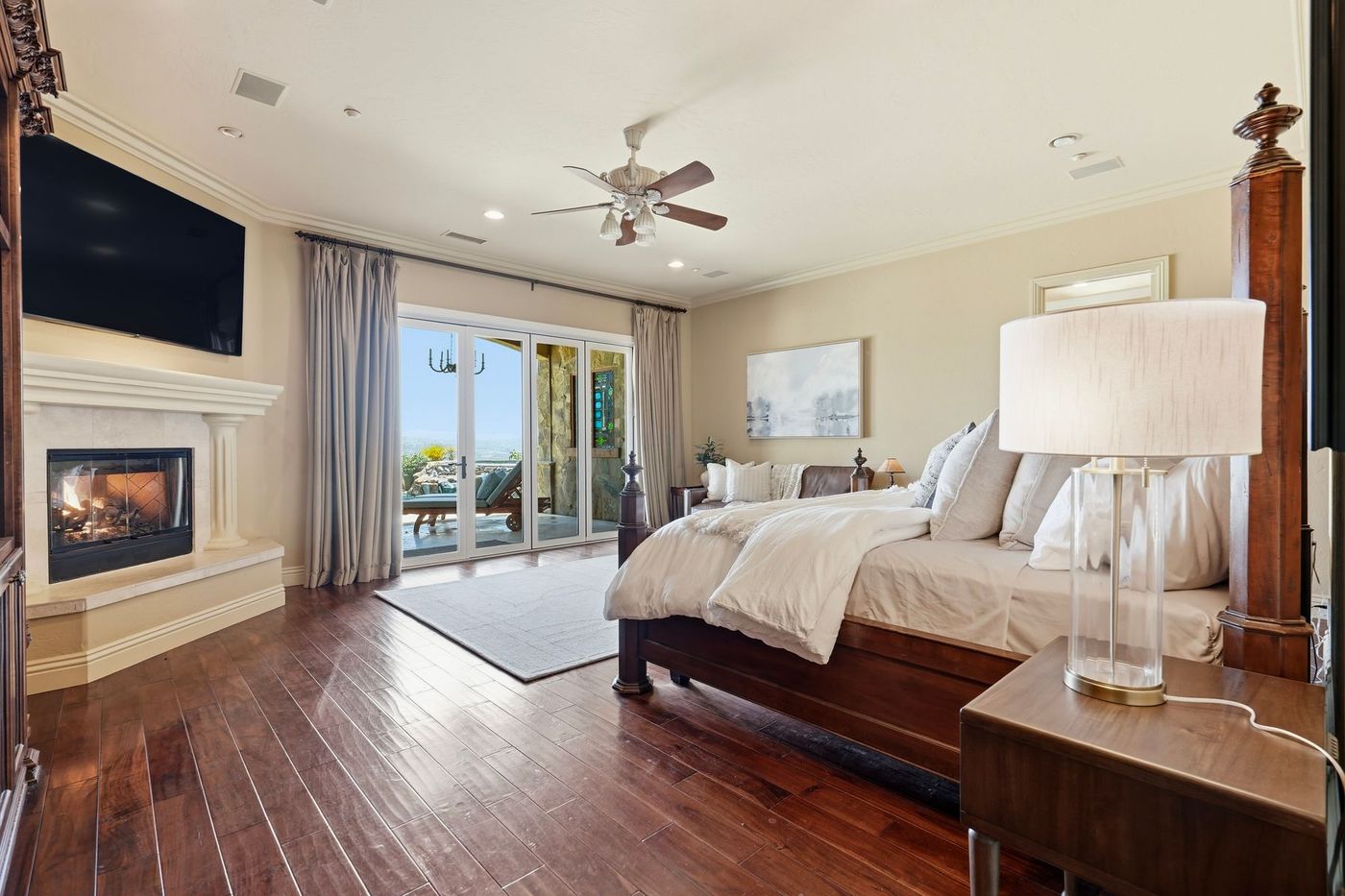 Primary suite with fireplace and folding glass doors to the pool deck